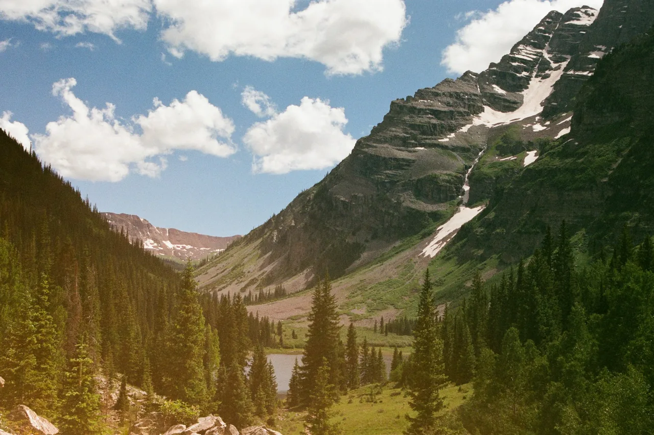 Sunlight crossing a Colorado mountain landscape at daybreak