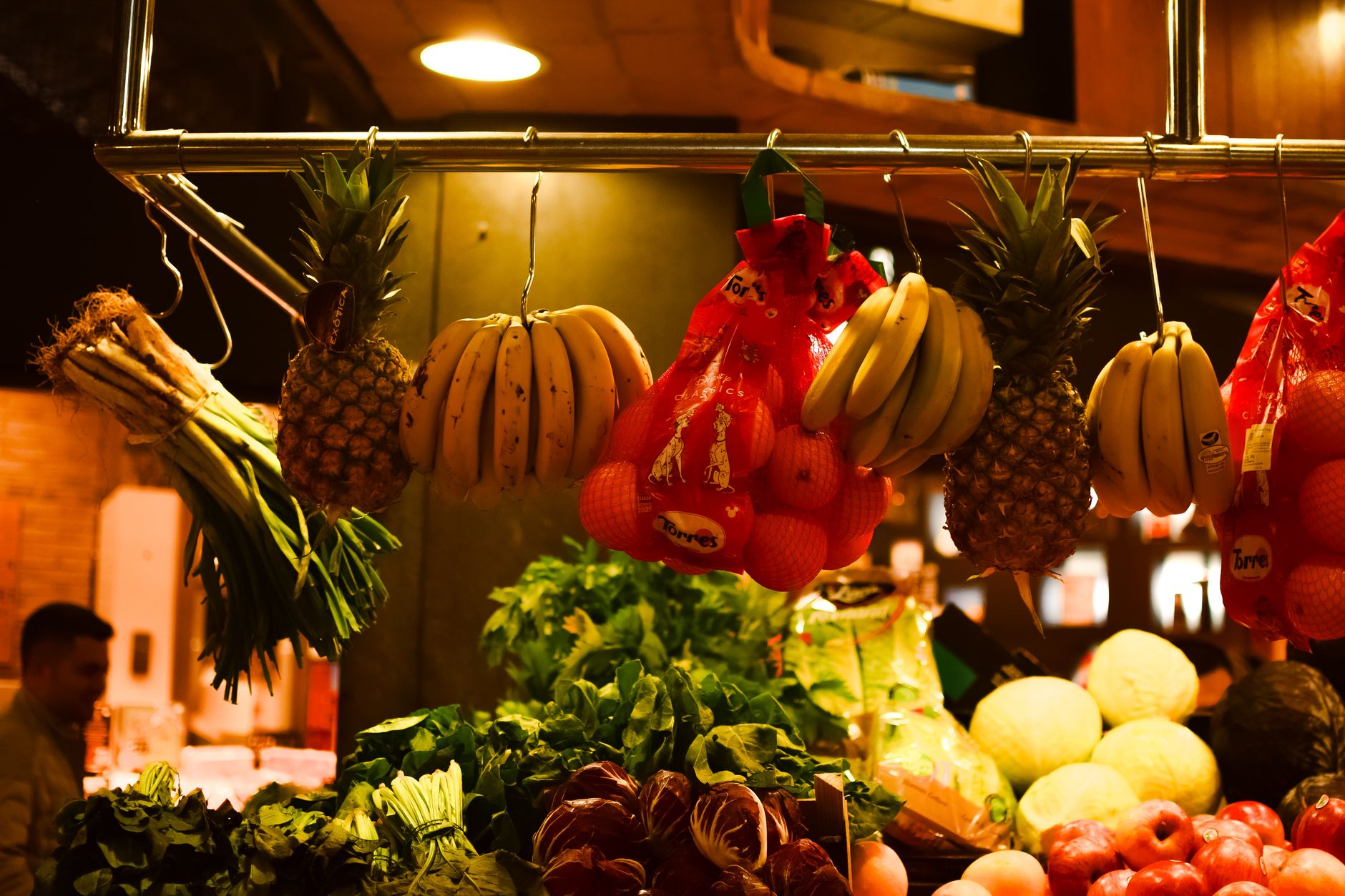 A spread of colorful fruits, vegetables, whole grains, and nuts on a wooden table